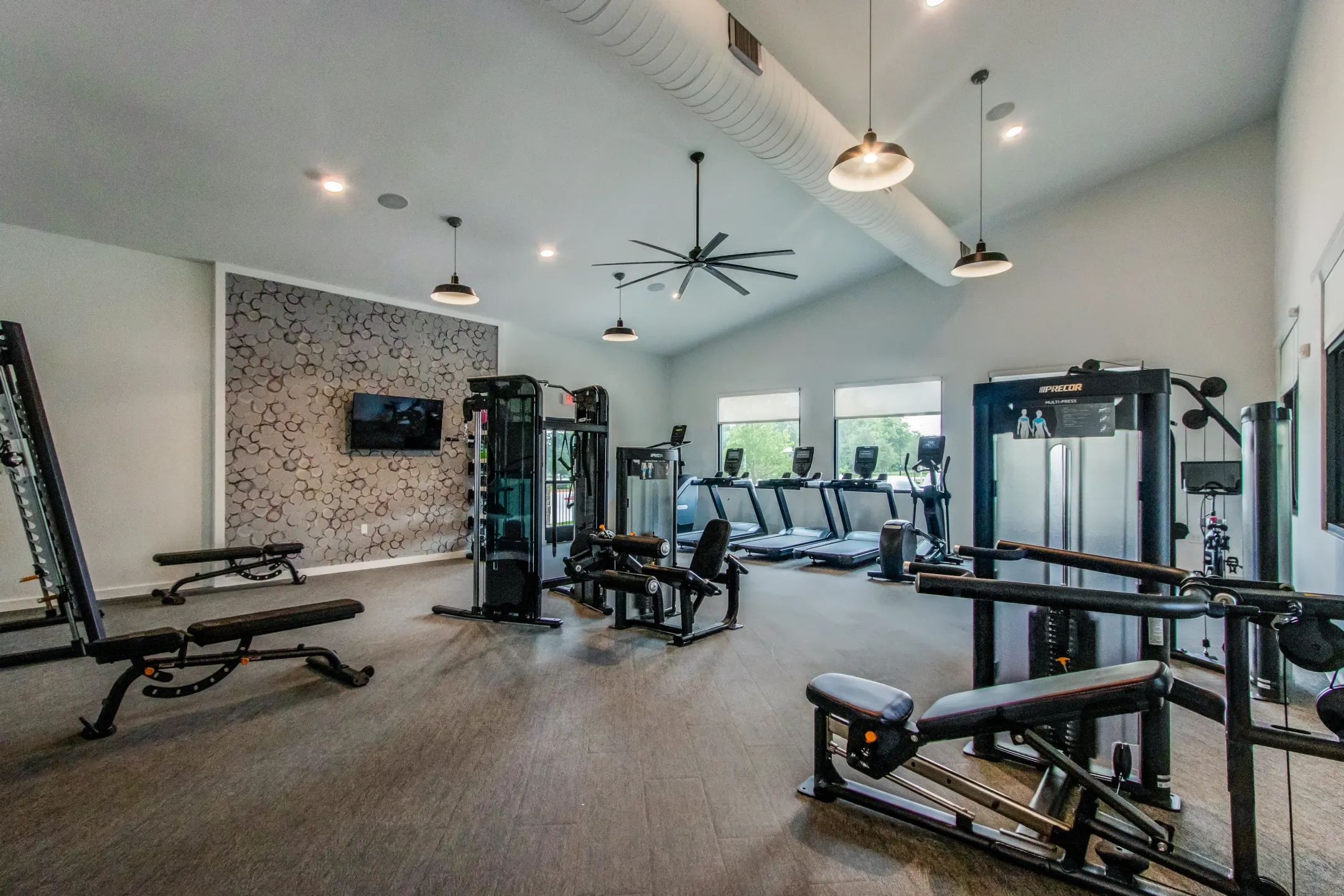 a gym room with equipment and a television at The Rushcreek