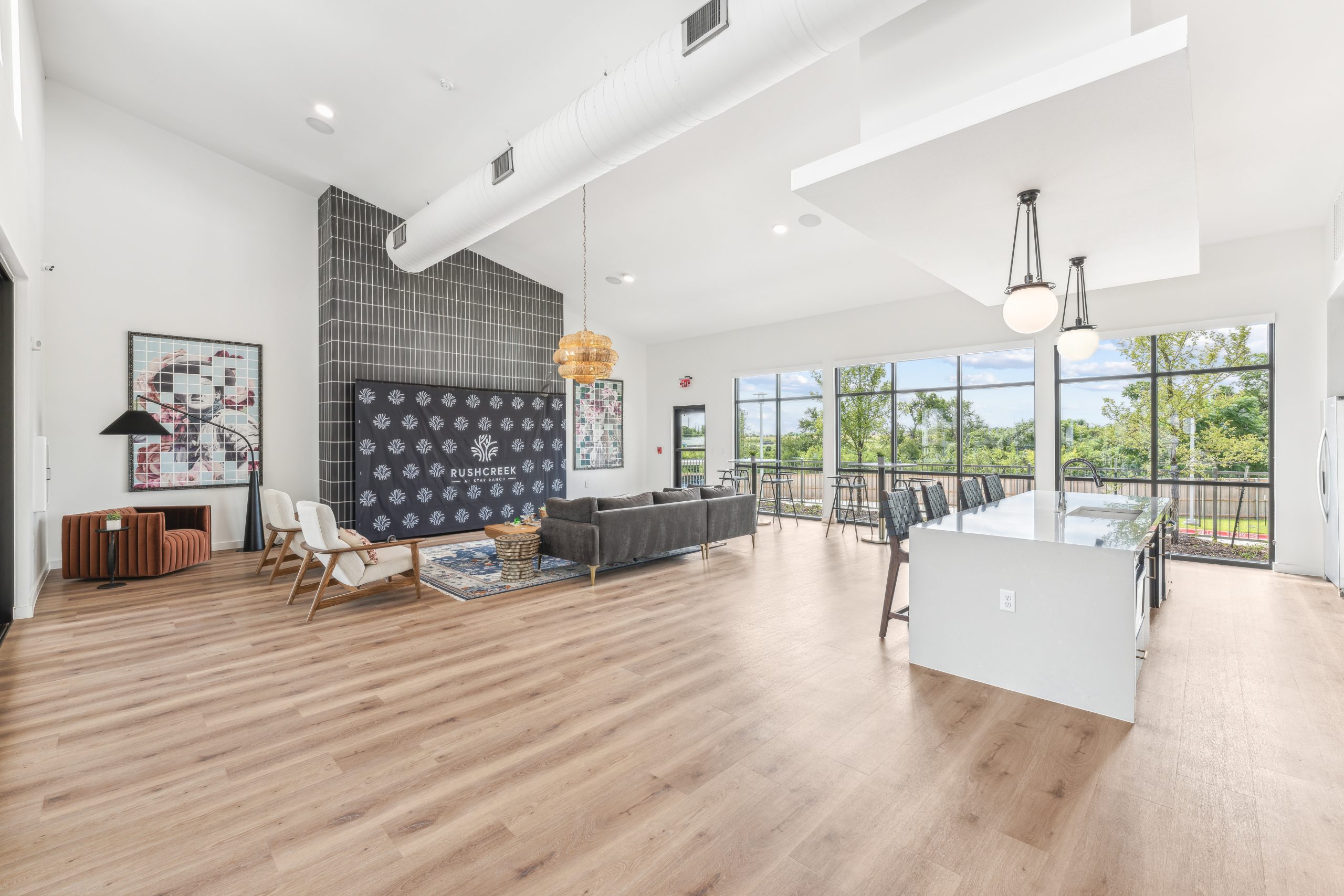 a large open living room with hardwood floors and a large window at The Rushcreek