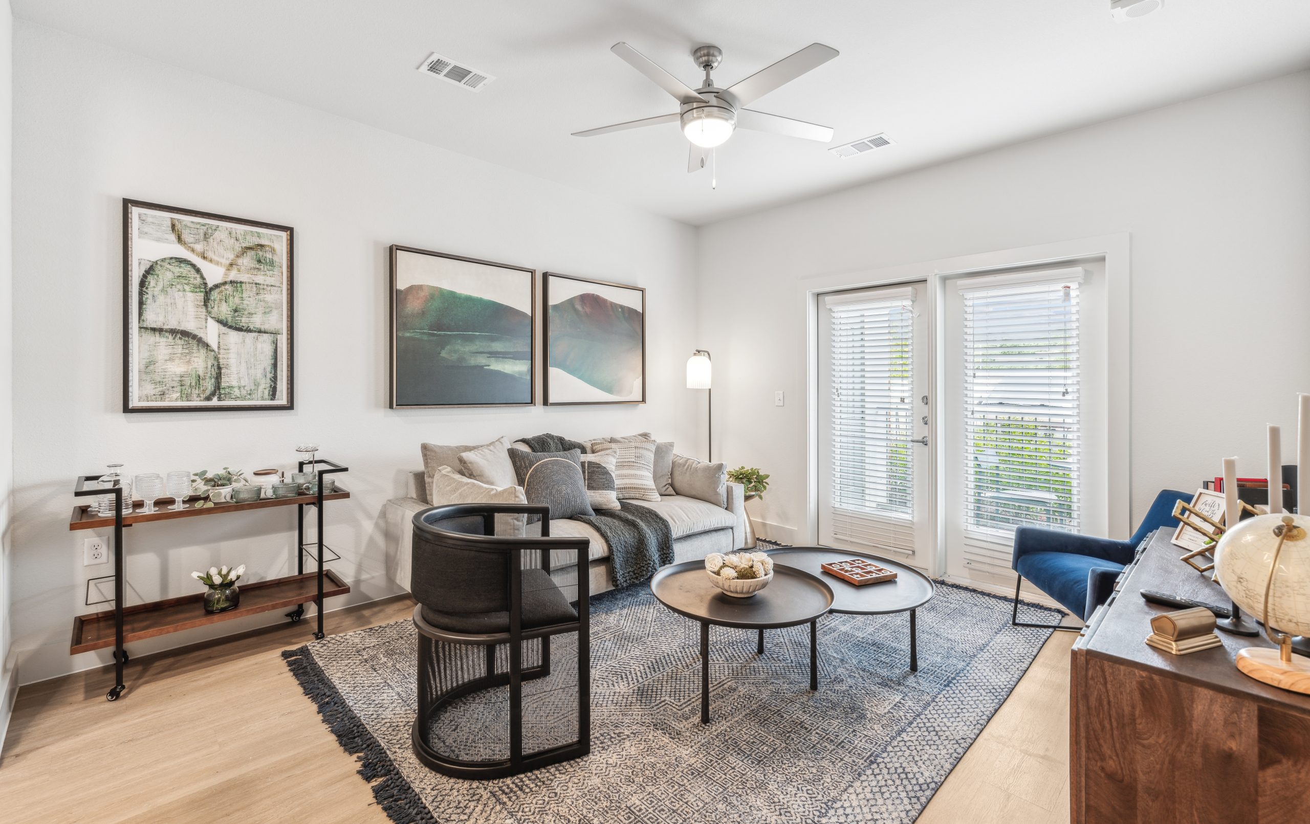a living room with a ceiling fan and hardwood floors at The Rushcreek
