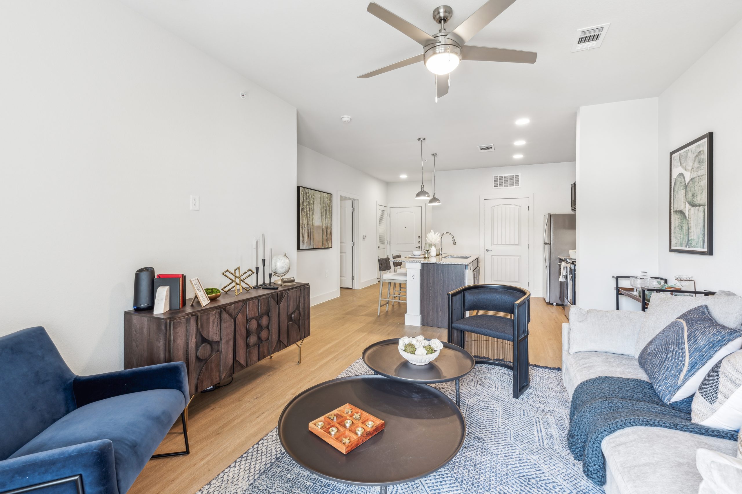 a living room with a ceiling fan and hardwood floors at The Rushcreek