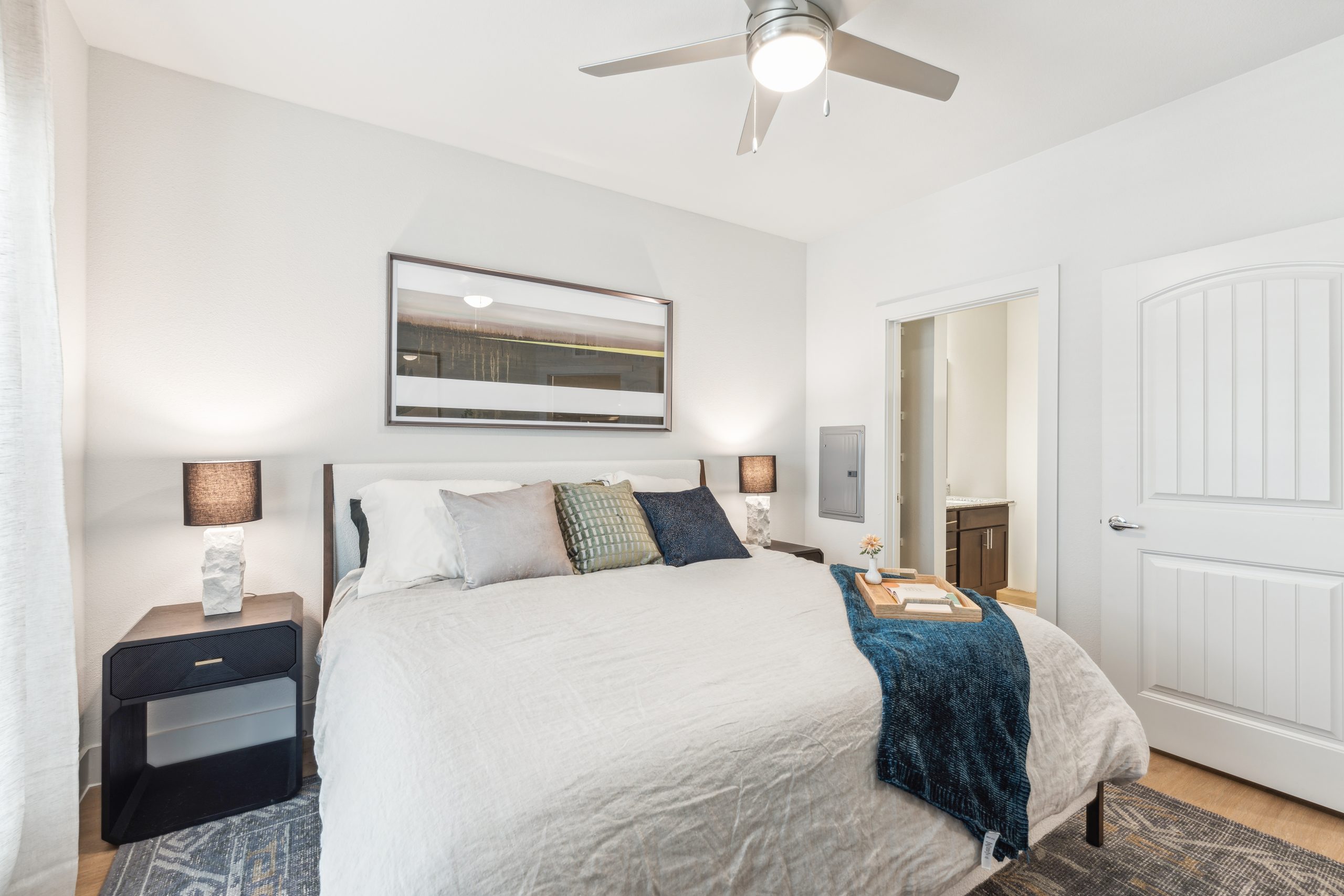 a bedroom with a white bed and ceiling fan at The Rushcreek