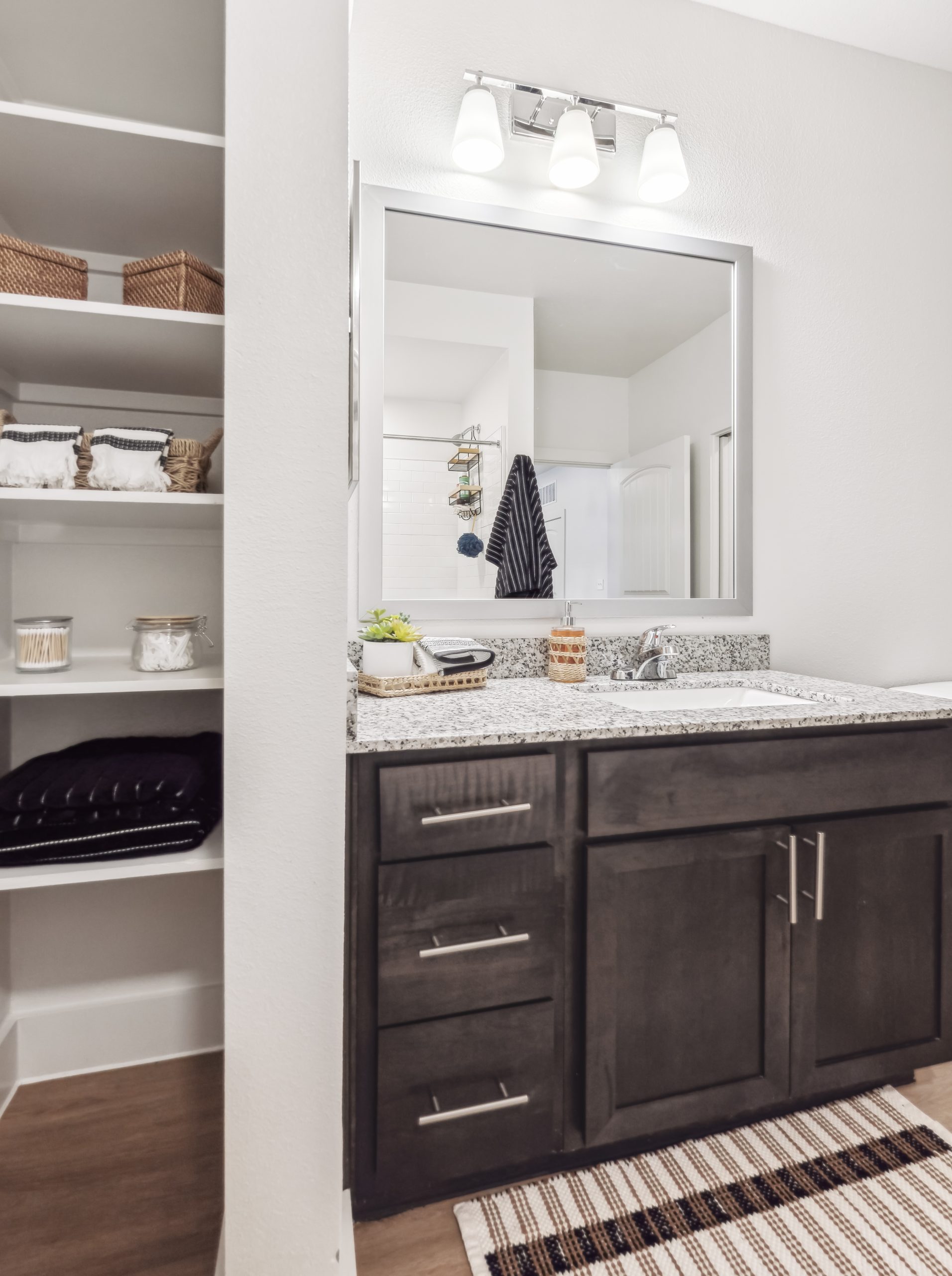 a bathroom with a large mirror and cabinets at The Rushcreek