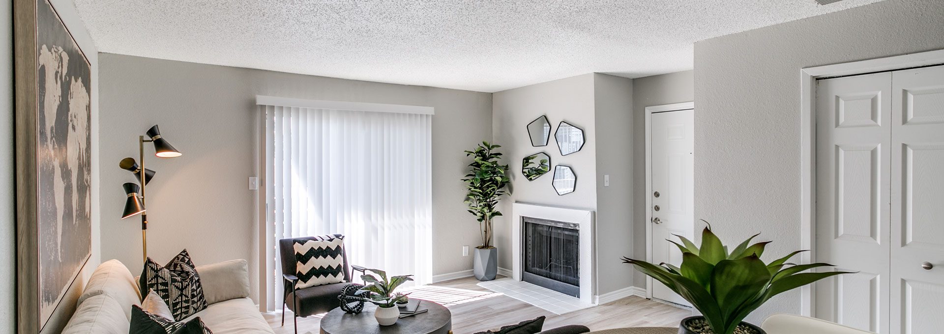 the living room has a fireplace and a white couch at The Falltree Apartments