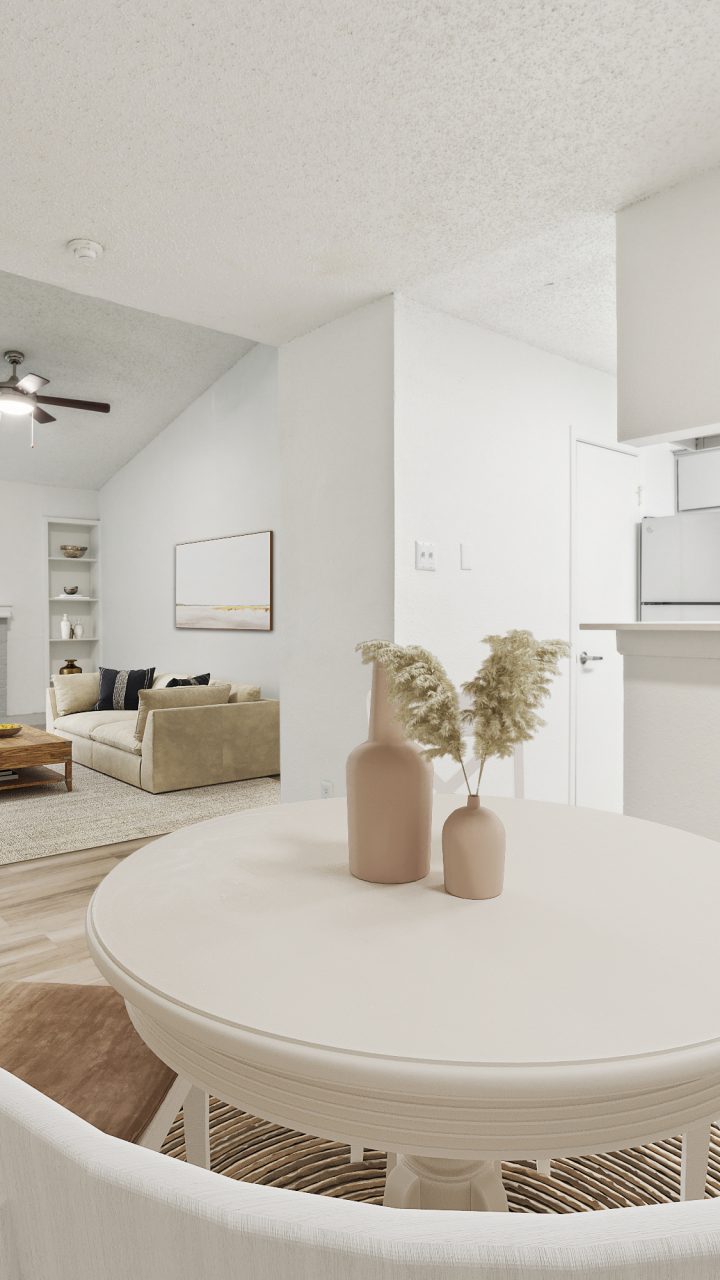 a dining room and kitchen area with white furniture at The Falltree Apartments