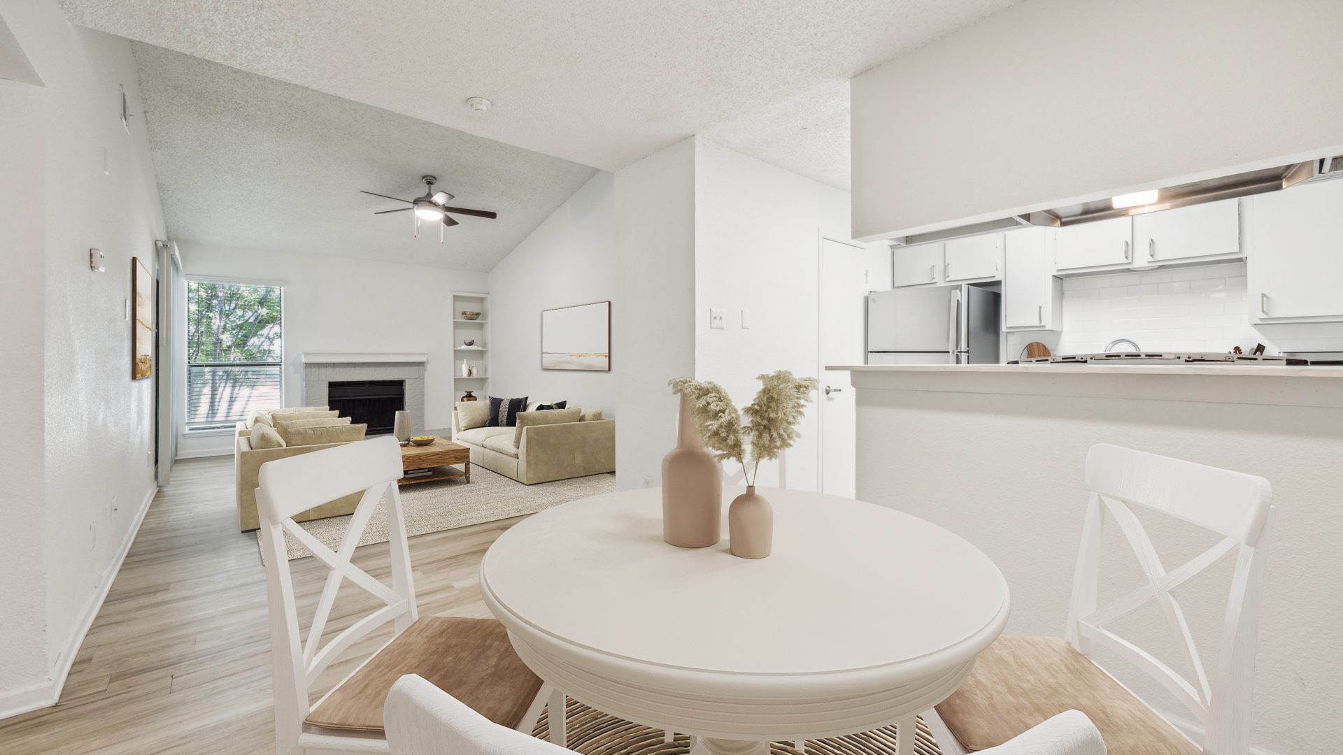 a dining room and kitchen area with white furniture at The Falltree Apartments