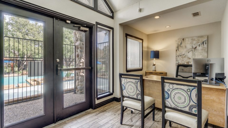 a home office with a sliding glass door and a table at The  Reid Apartments