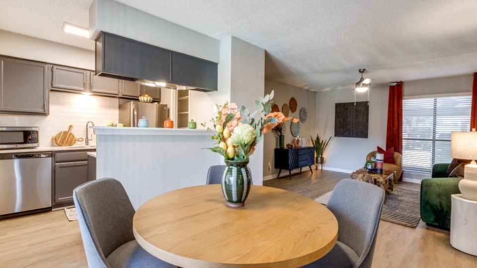 a dining room and kitchen area with a table and chairs at The  Reid Apartments