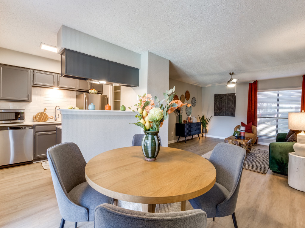 a dining room and kitchen area with a table and chairs at The Reid Apartments