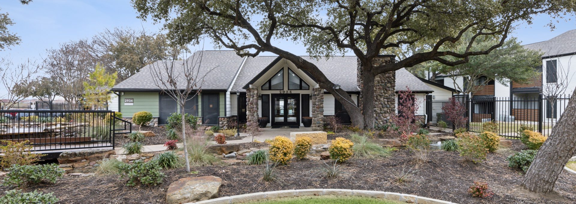 the front yard of a home with trees and grass at The  Reid Apartments