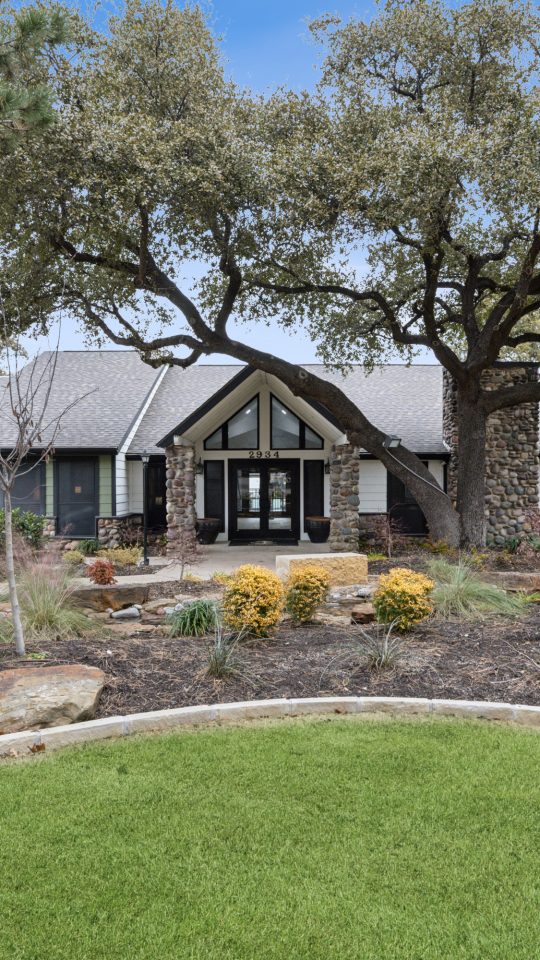 the front yard of a home with trees and grass at The  Reid Apartments