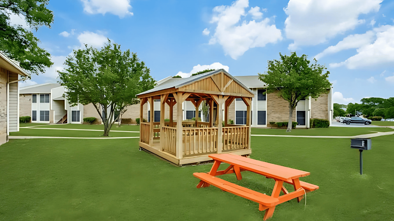 a picnic table and gazebo in a park at The Meadows on Merrill