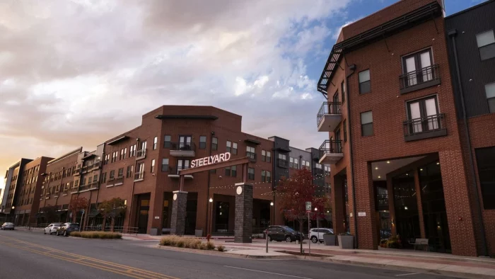 the building is made of brick and has a red brick facade at The Steelyard Apartments