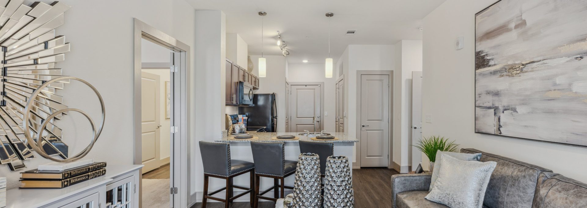 the living room has a ceiling fan and a couch at The Steelyard Apartments