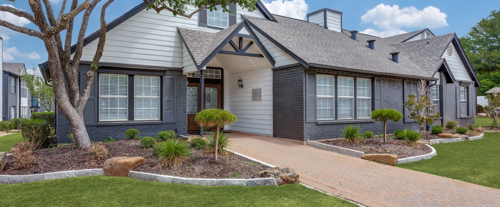 the front of a home with landscaping and a driveway at The Westley