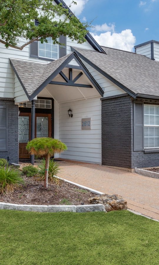 the front of a home with landscaping and a driveway at The Westley