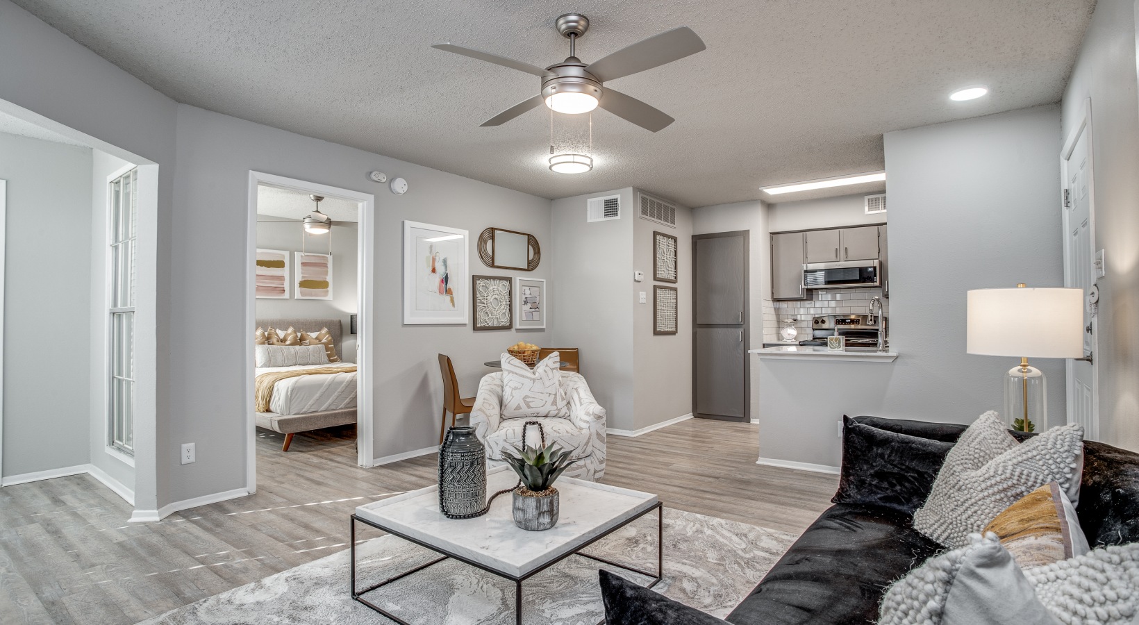 the living room has a ceiling fan and a couch at The Westley