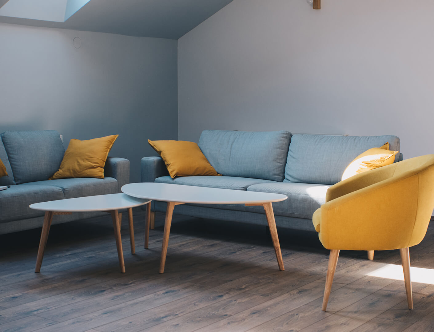 a living room with yellow and blue furniture at The Discovery Park Life Apartments