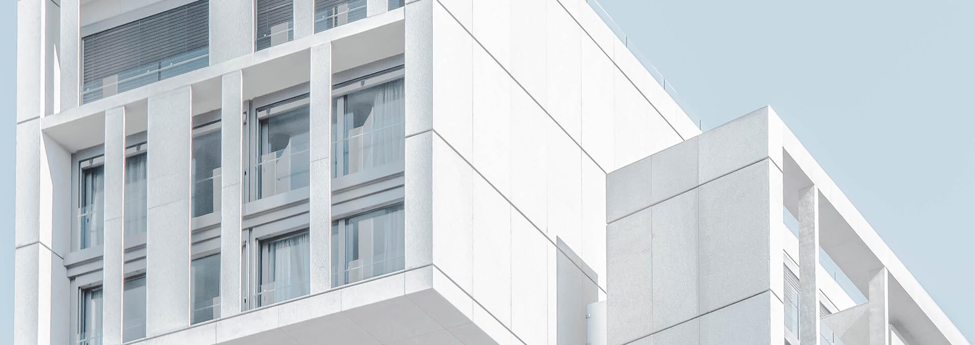 a white building with a balcony and stairs at The Discovery Park Life Apartments