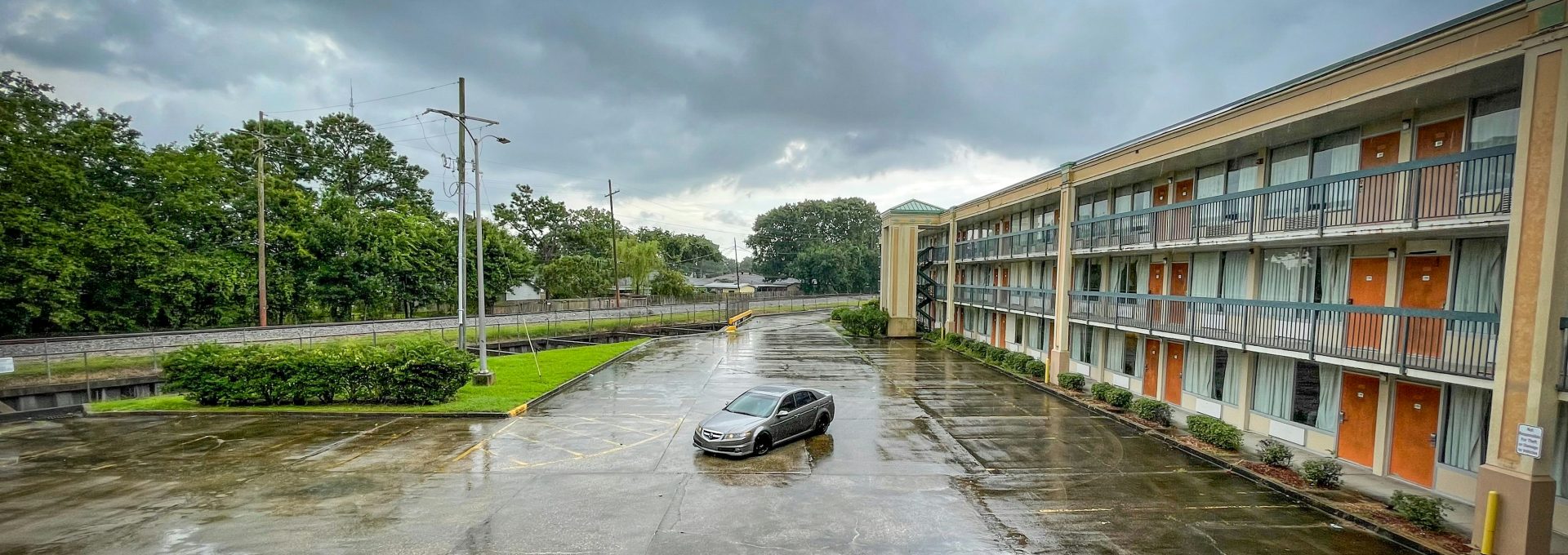 a car parked in a parking lot next to a building