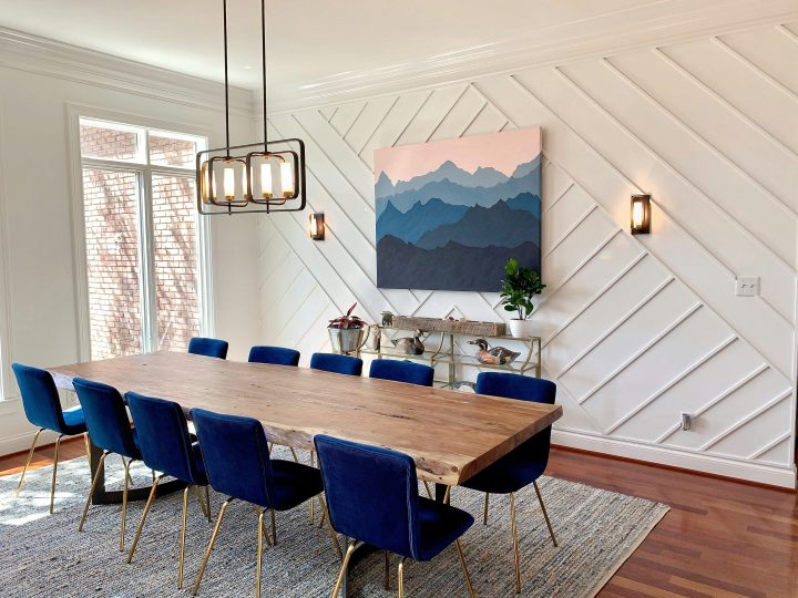 a dining room with blue chairs and a wooden table at The  Discovery Park Life Apartments