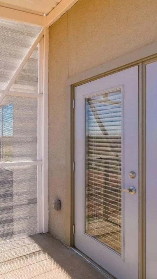 a balcony with sliding glass doors and a view of the outside at The Argon