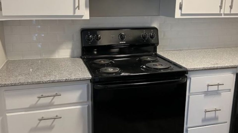 a black stove and oven in a kitchen at The  Courtyard