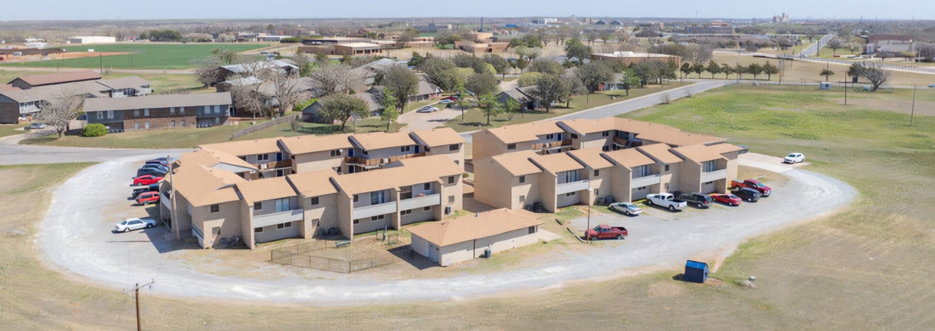 an aerial view of a large ranch with a large parking lot at The  Courtyard