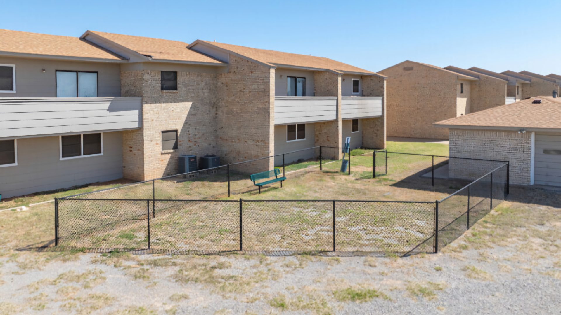 the apartment complex has a fenced in yard at The Courtyard
