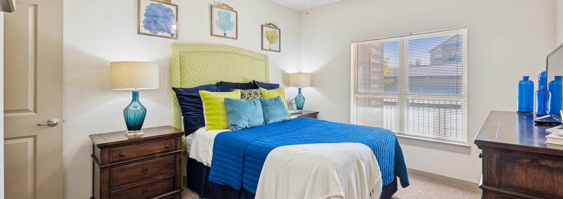 a bedroom with a bed and a dresser
