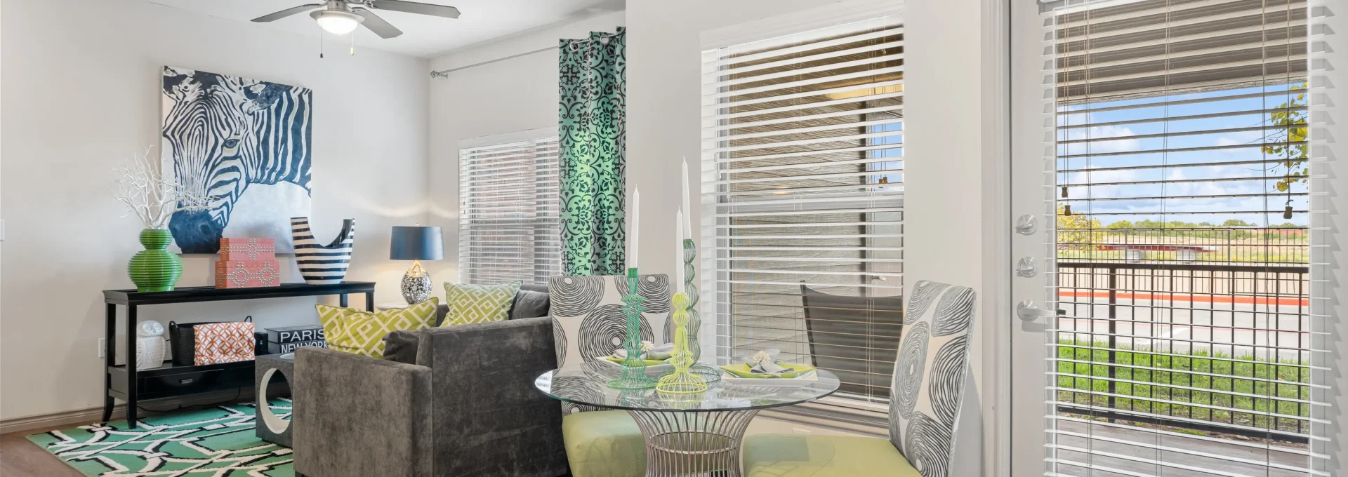 the living room has a sliding glass door and a table at The  BLVD