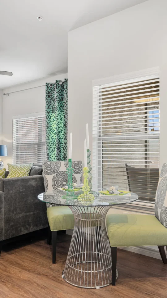 the living room has a sliding glass door and a table at The  BLVD