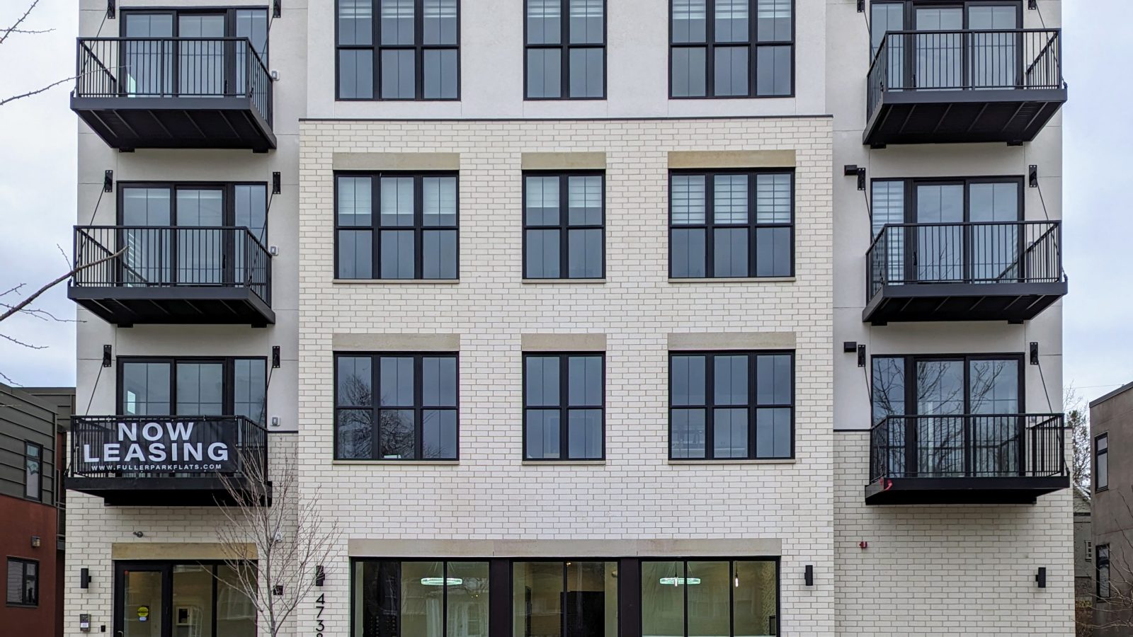 the front of a four story apartment building at Fuller Park Flats