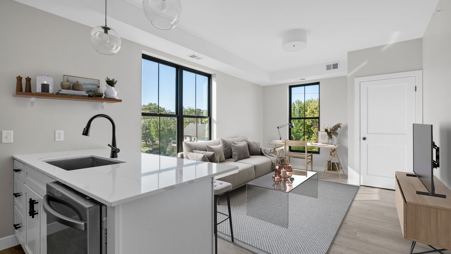 a modern kitchen and living room with a large window at Fuller Park Flats