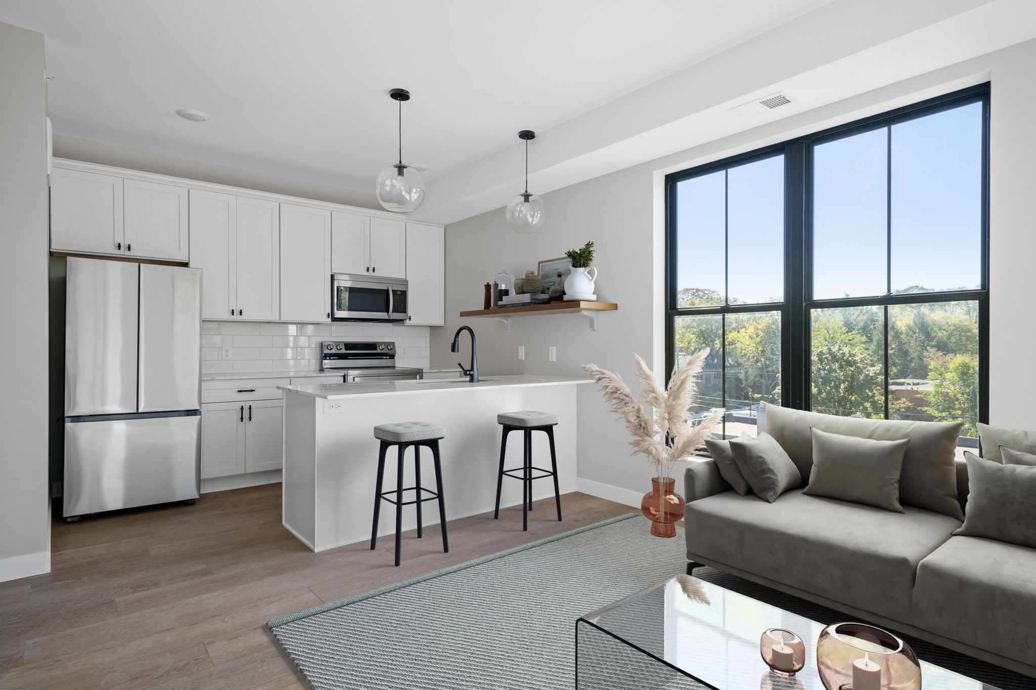 a kitchen and living room with windows and a couch at The Fuller Park Flats