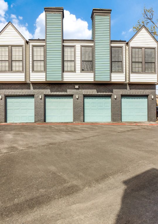 the parking lot at a residential complex with two garages at The  Laney