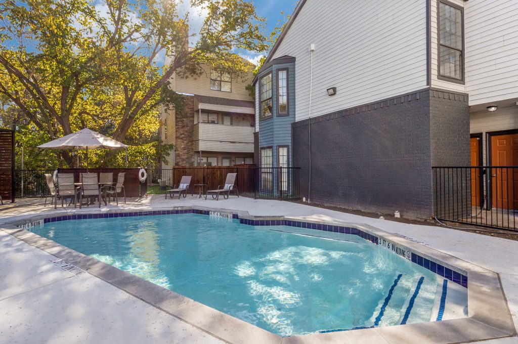 a pool in front of a house with a patio at The  Laney