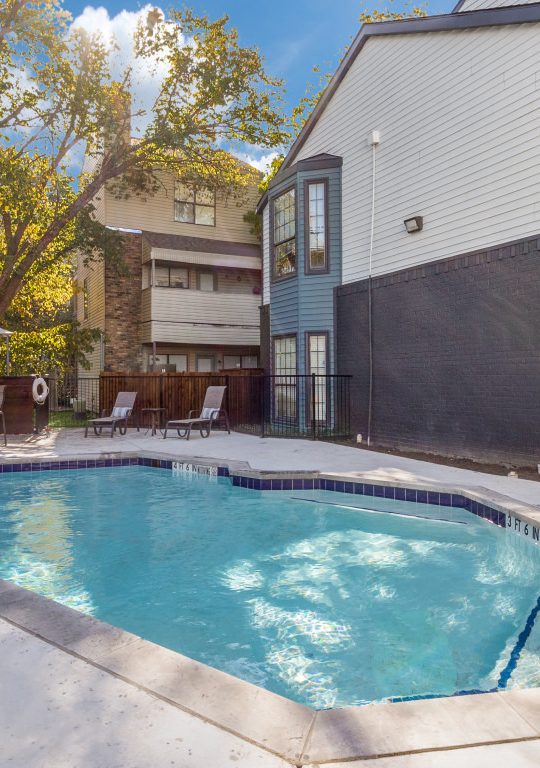 a pool in front of a house with a patio at The  Laney