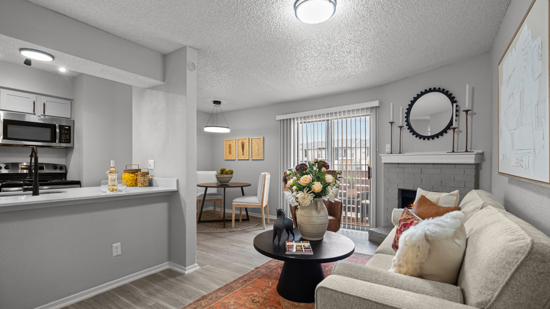 a living room and kitchen area with a couch and coffee table at The  Dahlia