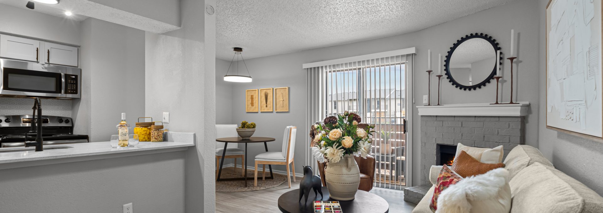 a living room and kitchen area with a couch and coffee table at The  Dahlia