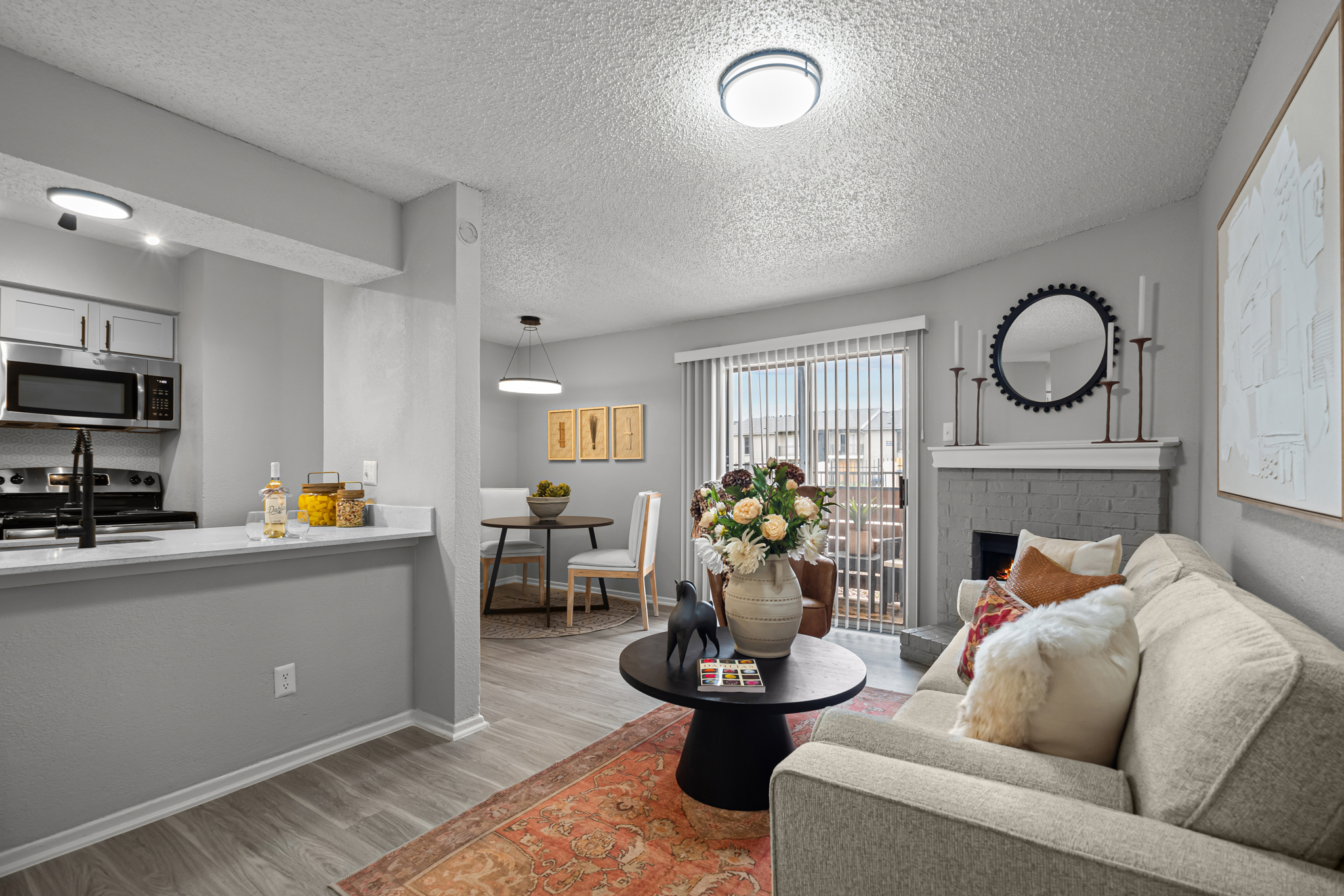 a living room and kitchen area with a couch and coffee table at The Dahlia