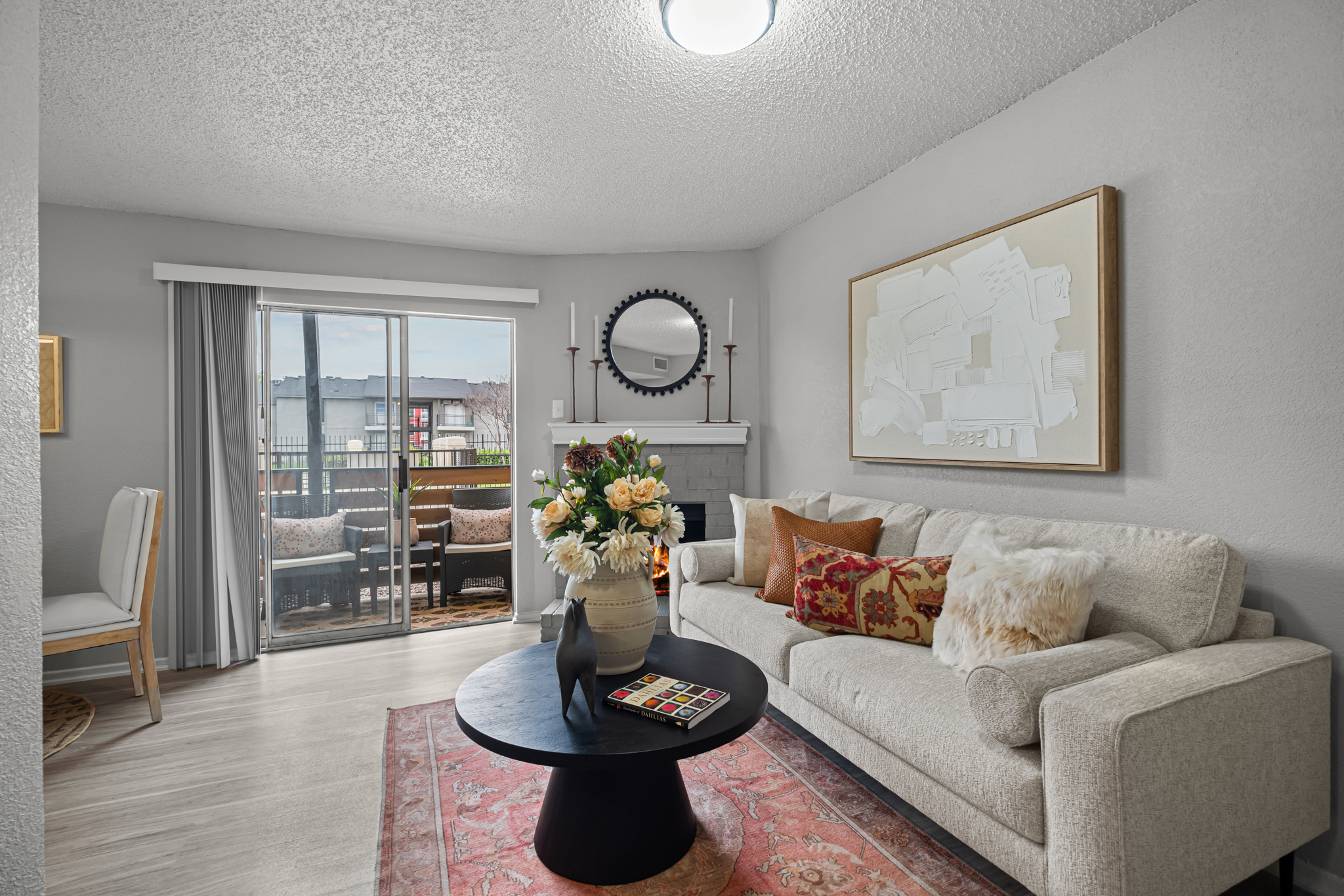 a living room with a couch, coffee table and a sliding glass door at The Dahlia