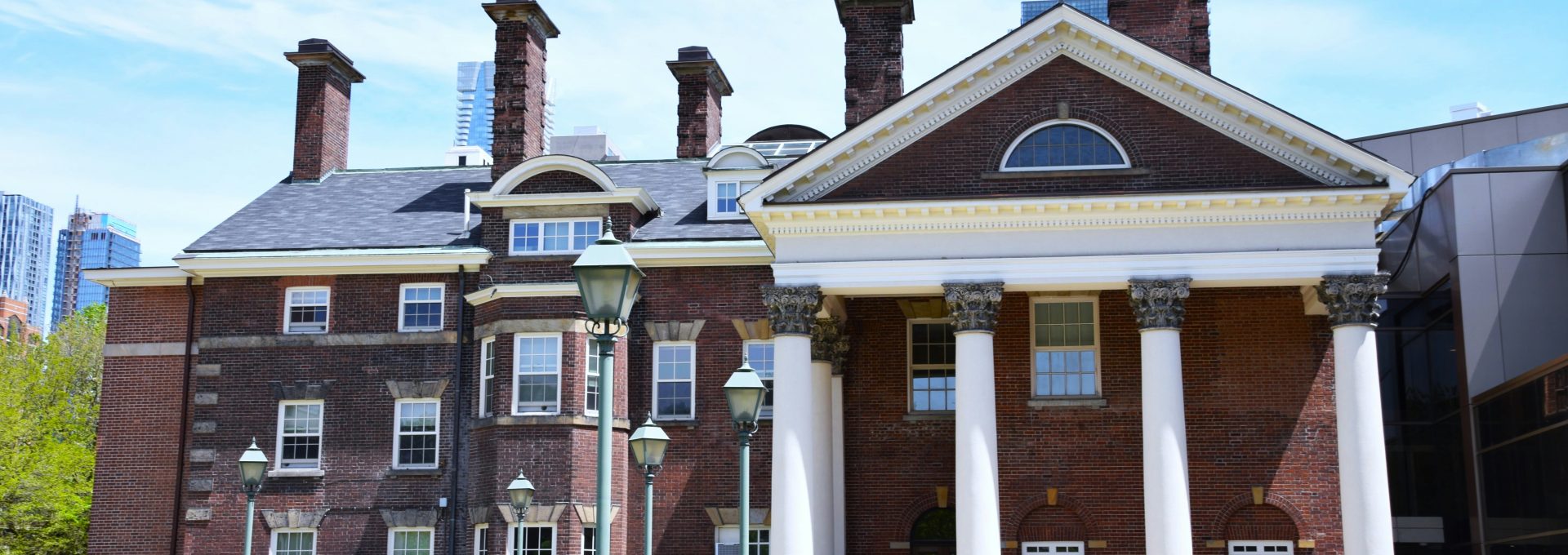 a large brick building with columns and a clock tower