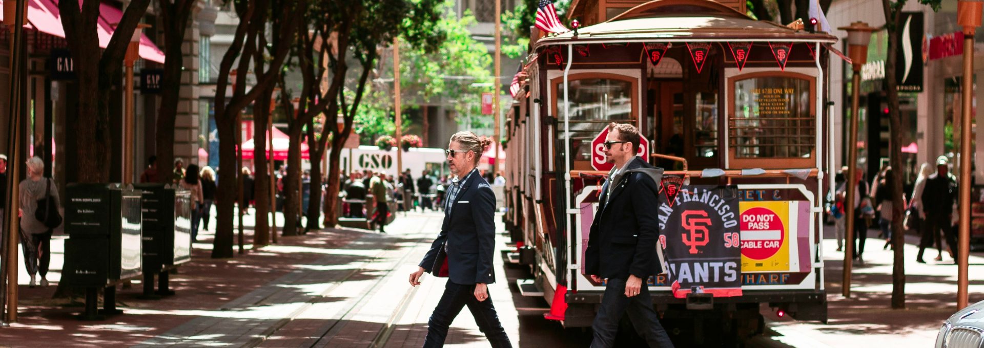 person passing through road beside tram
