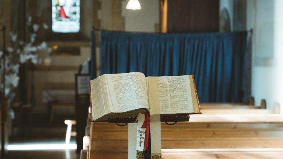 opened book on brown wooden bench