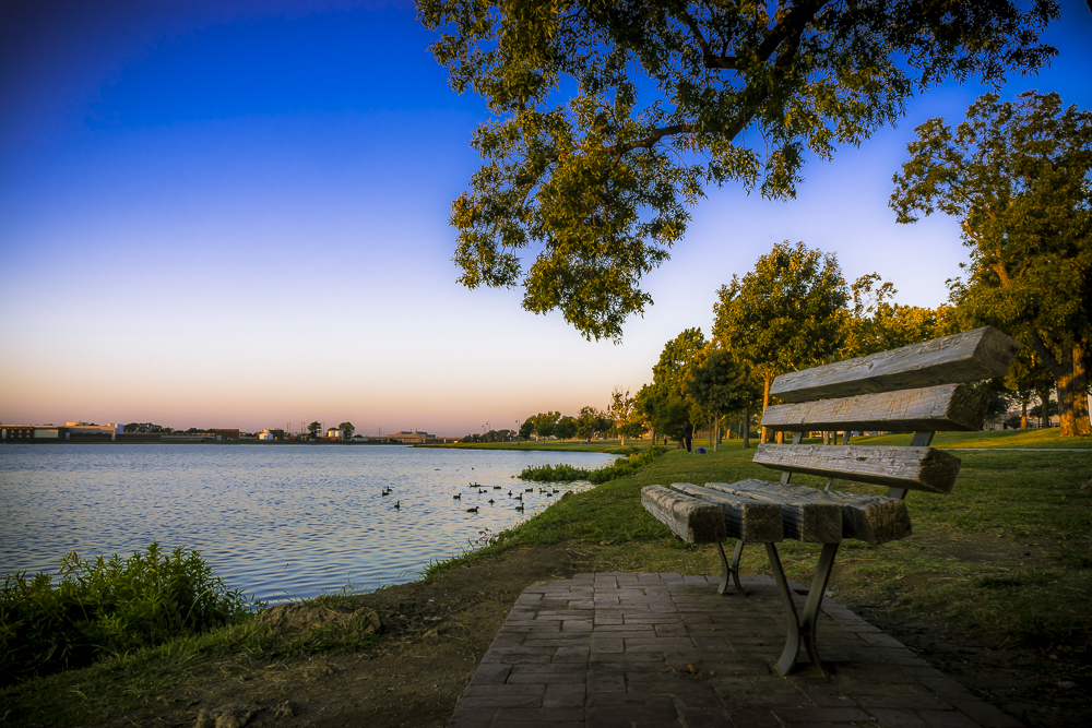 a bench sitting next to a body of water