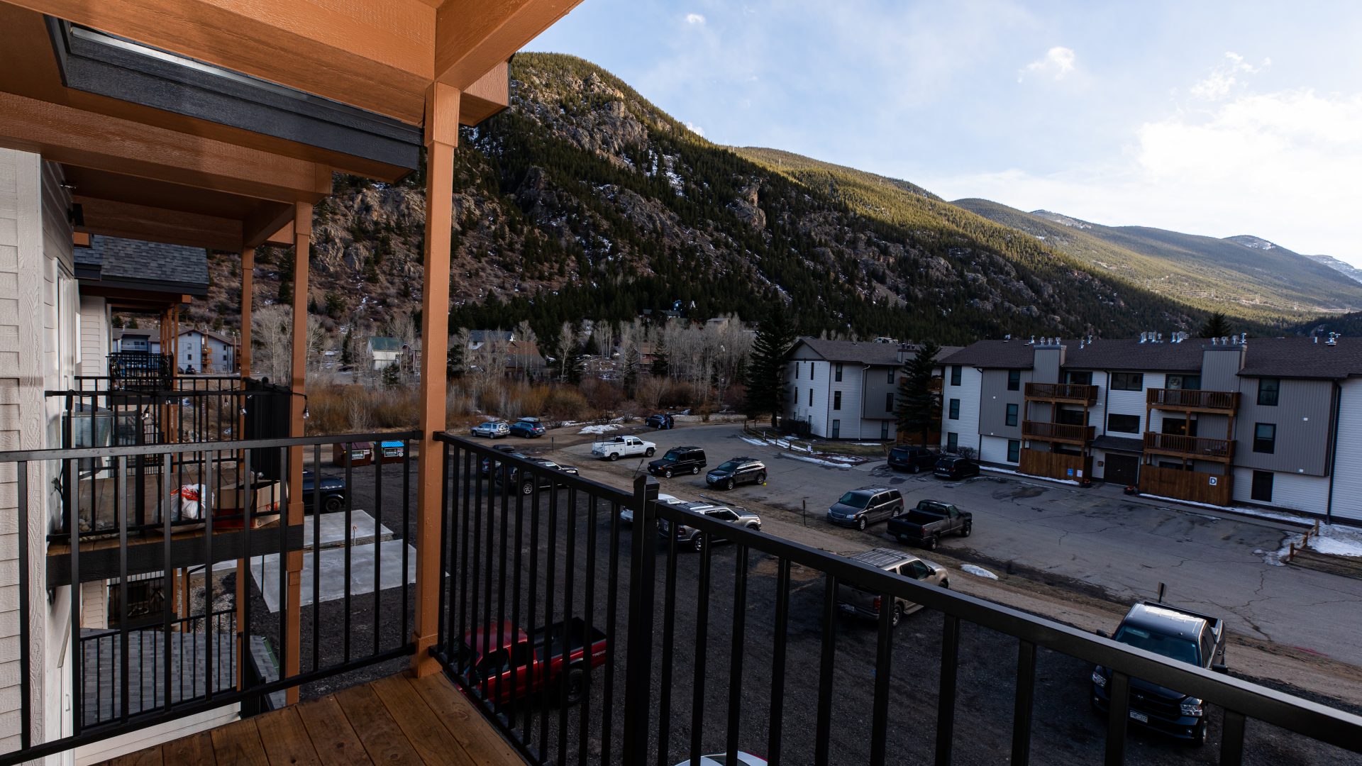 a balcony with a view of mountains and a parking lot at The Bighorn Crossing