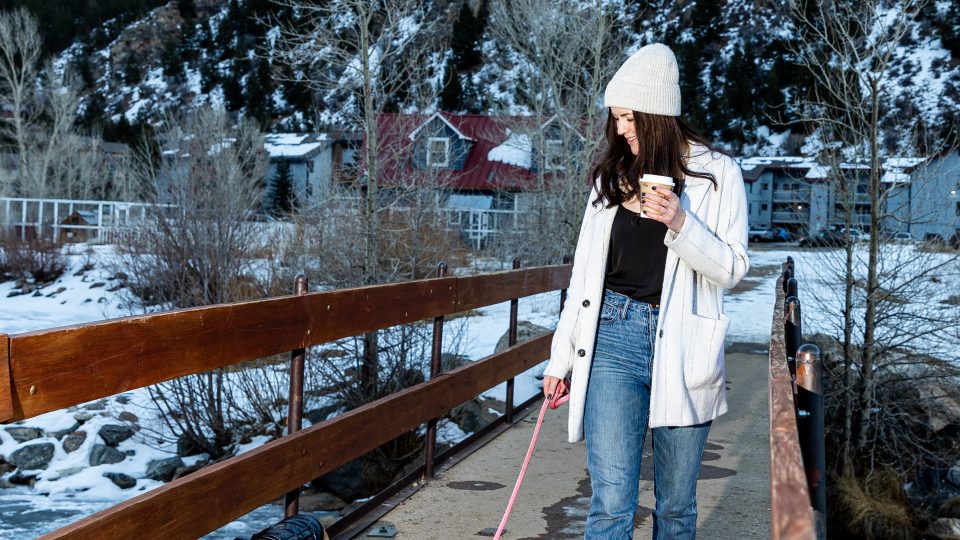 a woman walking her dog on a bridge at The Bighorn Crossing