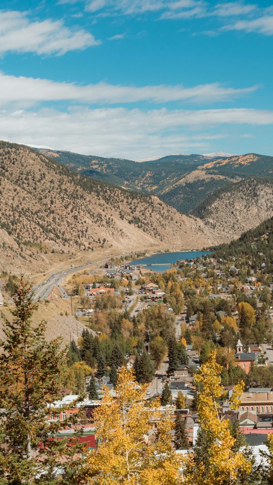 a scenic view of a town surrounded by mountains