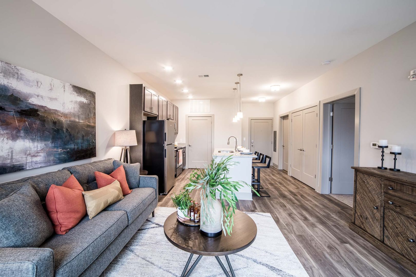 the living room and kitchen area of a new apartment at The River House