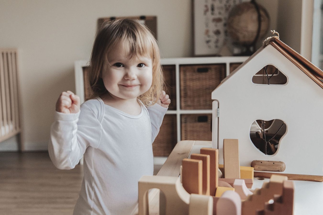 a little girl playing with wooden blocks in a room at The parcHAUS